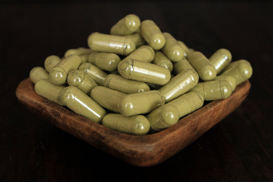 EdengrowS Green, White and Red Maeng Da kratom capsules in a saucer