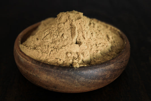Fresh fine blue lotus powder shown in wooden bowl